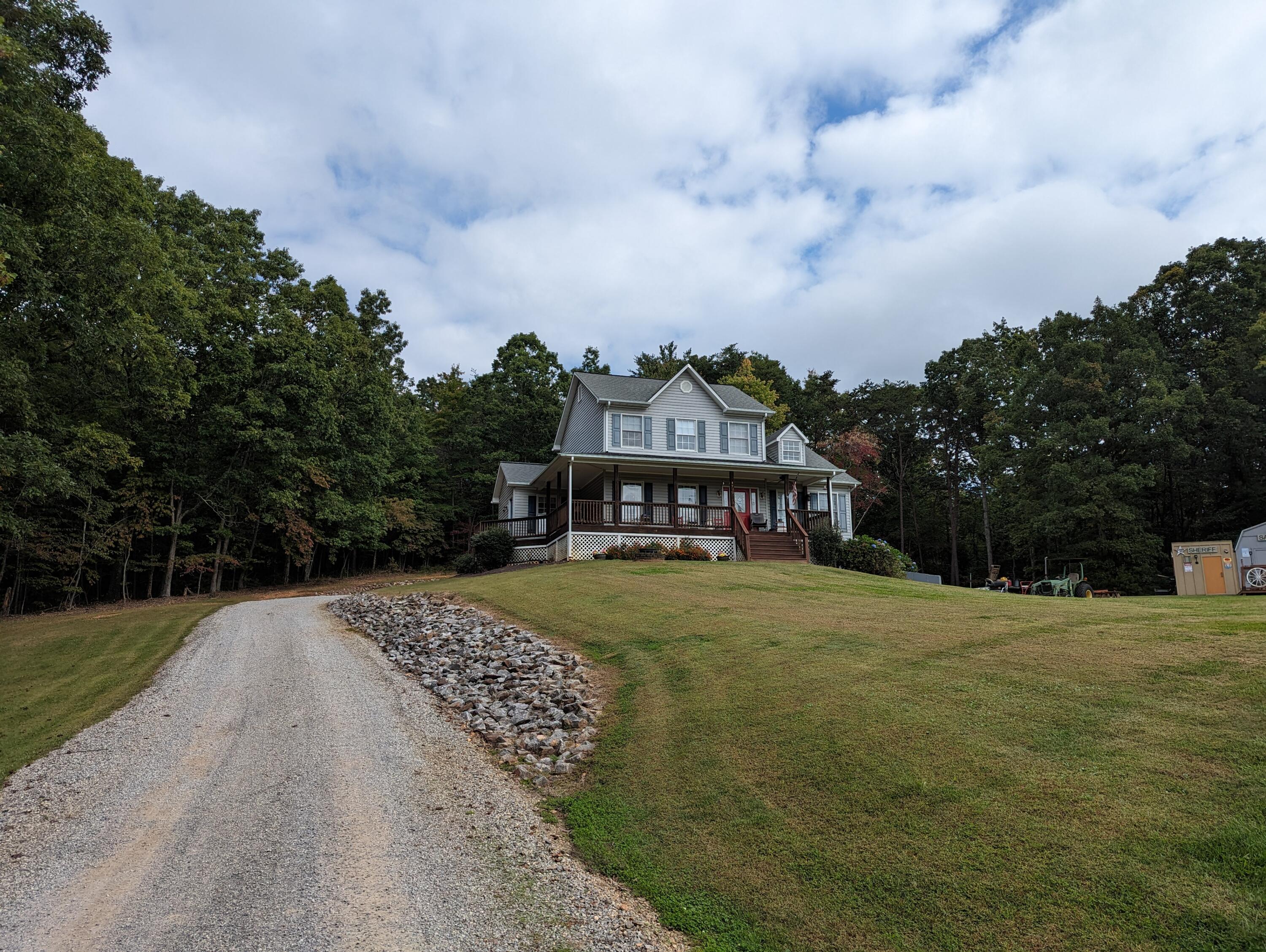 4715 Providence Church Road Ferrum, VA 24088 - Photo 2 of 46 a view of a big house with a big yard and large trees