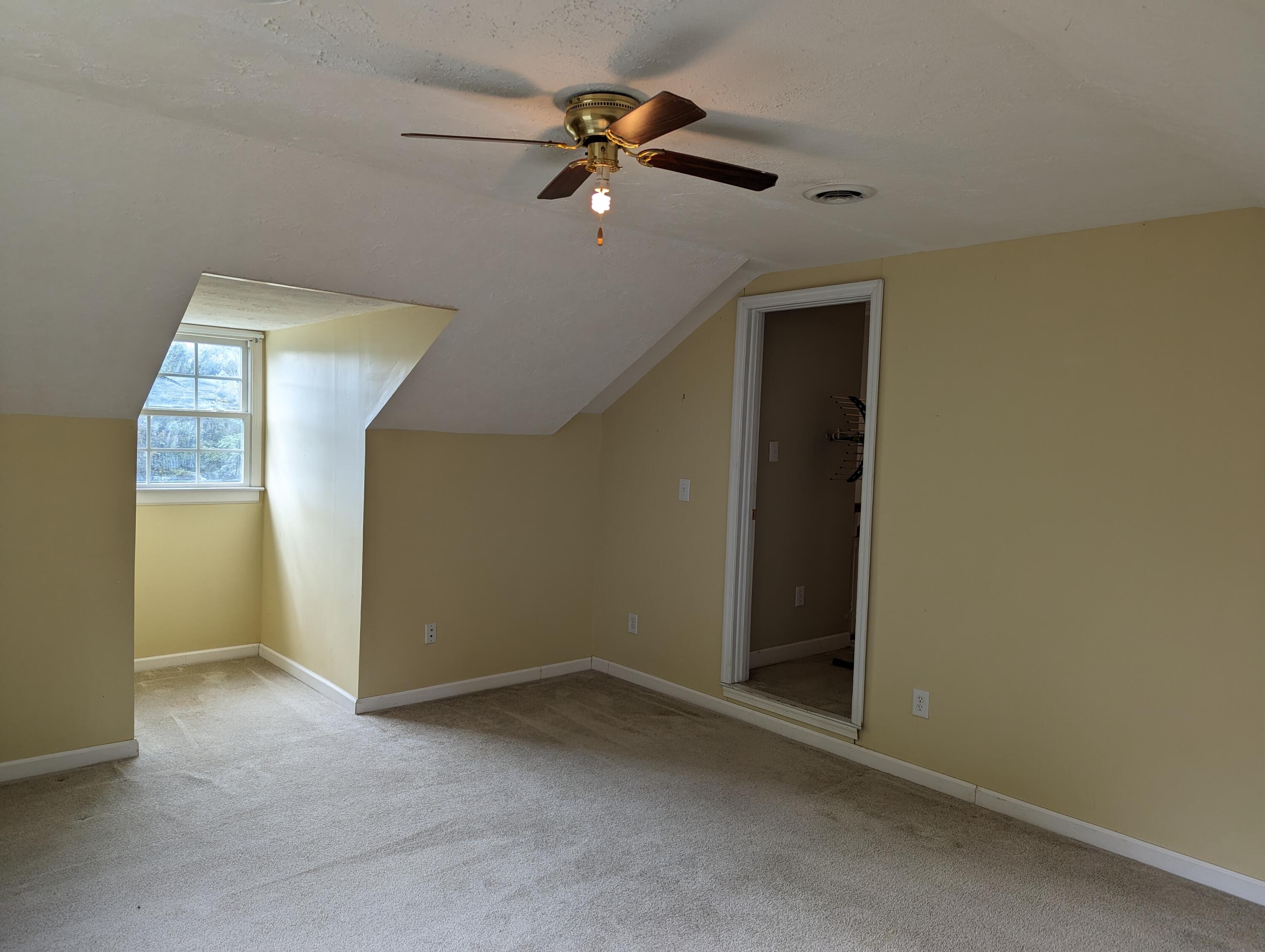 4715 Providence Church Road Ferrum, VA 24088 - Photo 29 of 46 an empty room with closet and a chandelier fan