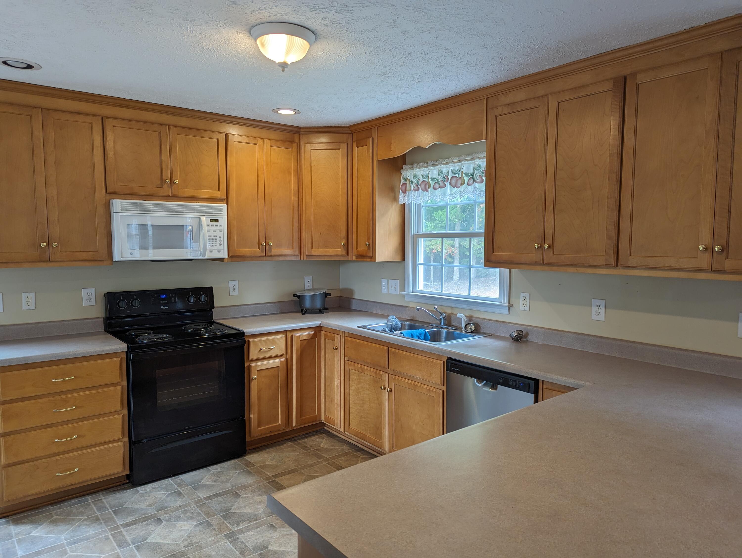 4715 Providence Church Road Ferrum, VA 24088 - Photo 4 of 46 a kitchen with a sink stove and cabinets