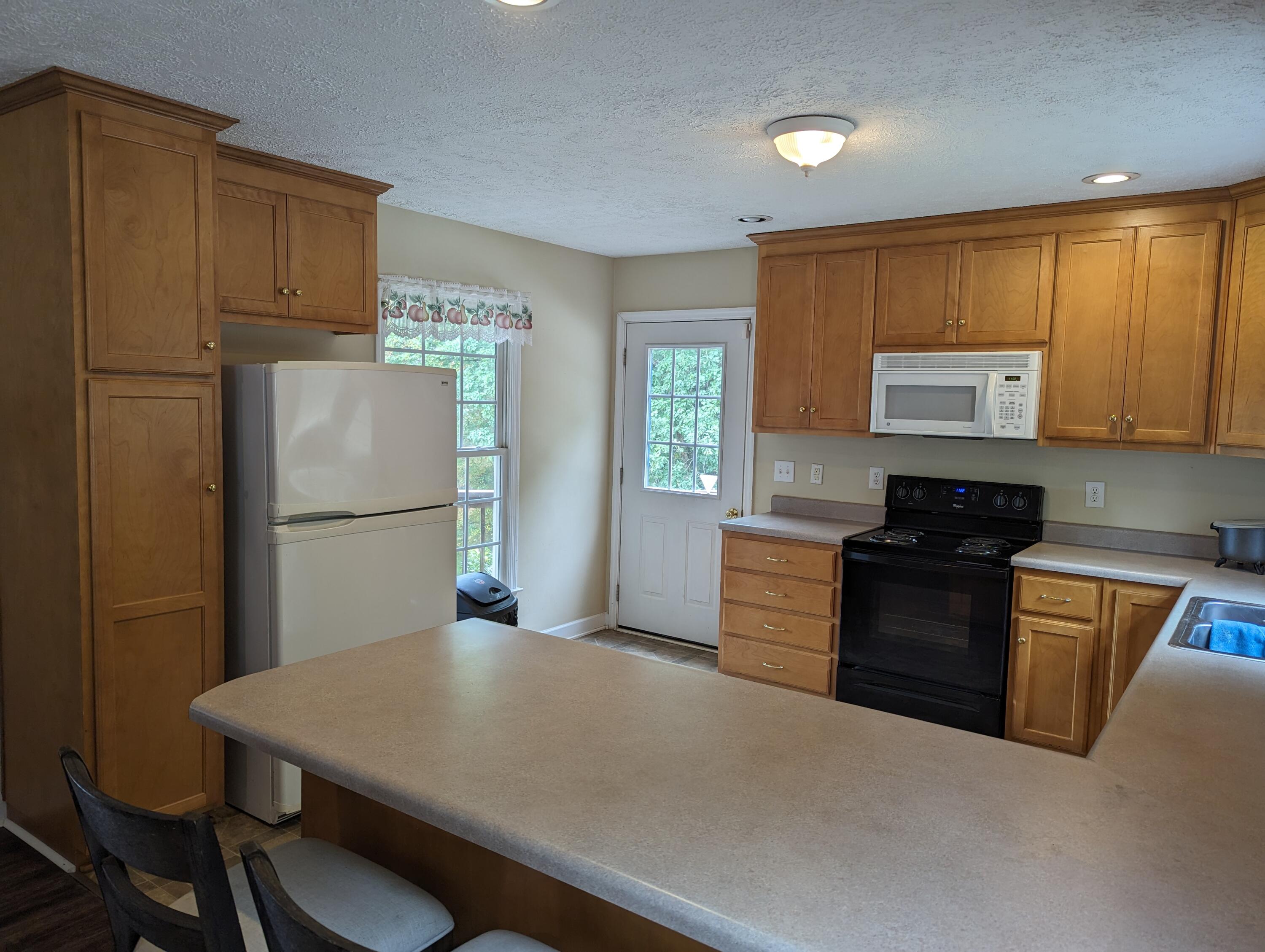 4715 Providence Church Road Ferrum, VA 24088 - Photo 5 of 46 a kitchen with a refrigerator and a stove top oven