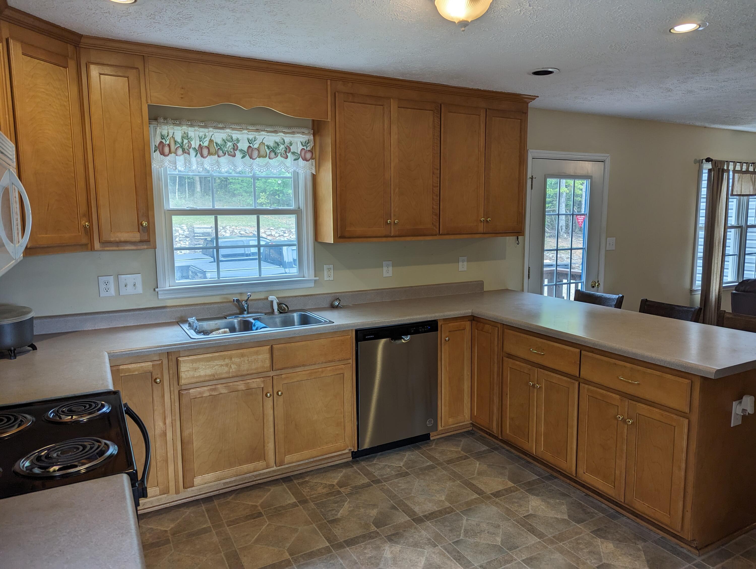 4715 Providence Church Road Ferrum, VA 24088 - Photo 6 of 46 a kitchen with sink cabinets and window