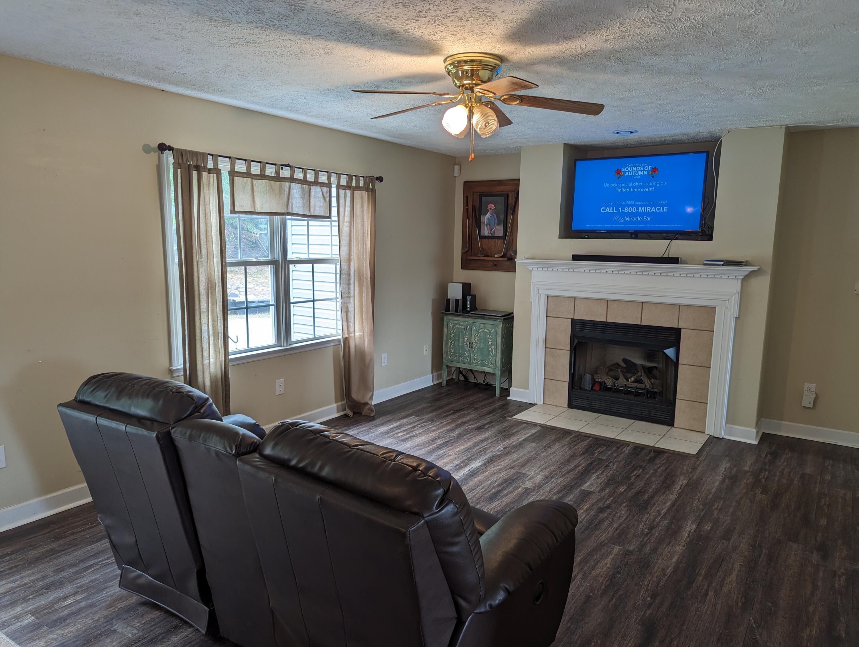 4715 Providence Church Road Ferrum, VA 24088 - Photo 9 of 46 a living room with furniture and a fireplace