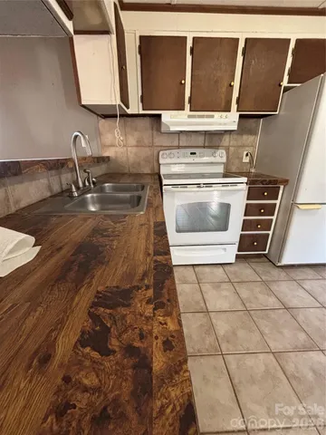 a kitchen with a sink and a stove top oven