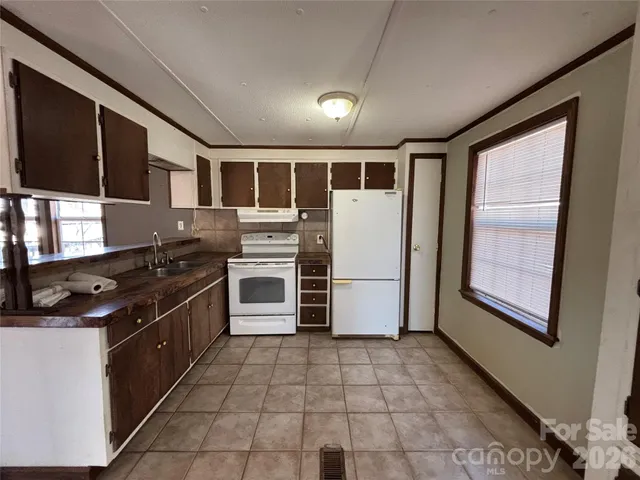a kitchen with stainless steel appliances granite countertop a stove and a refrigerator