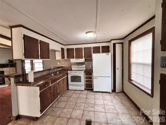 a kitchen with stainless steel appliances granite countertop a refrigerator oven a sink and dishwasher