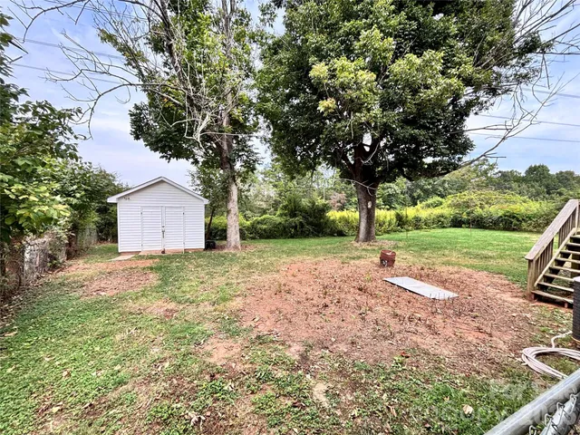 a view of backyard with large trees