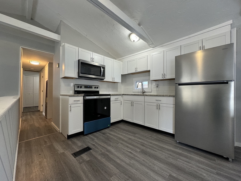 16 Schoolhouse Cross Road Brookfield, MA 01506 - Photo 4 of 39 a kitchen with a sink a refrigerator and a microwave