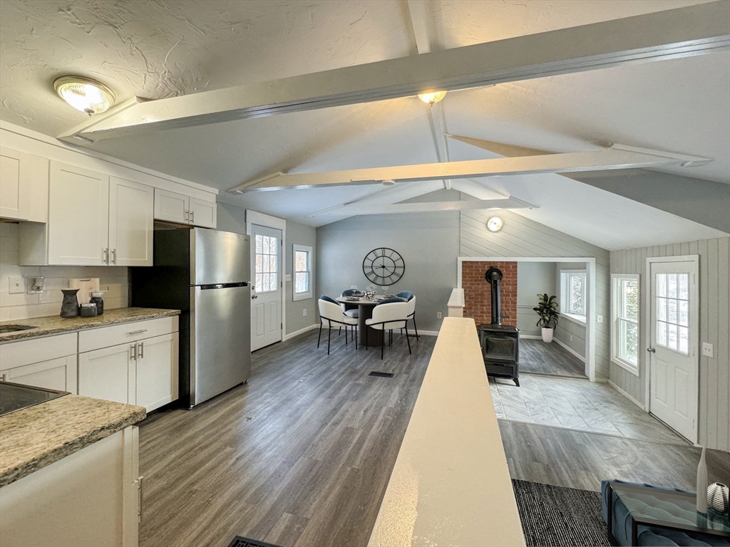 16 Schoolhouse Cross Road Brookfield, MA 01506 - Photo 7 of 39 a large kitchen with cabinets chairs wooden floor and stainless steel appliances