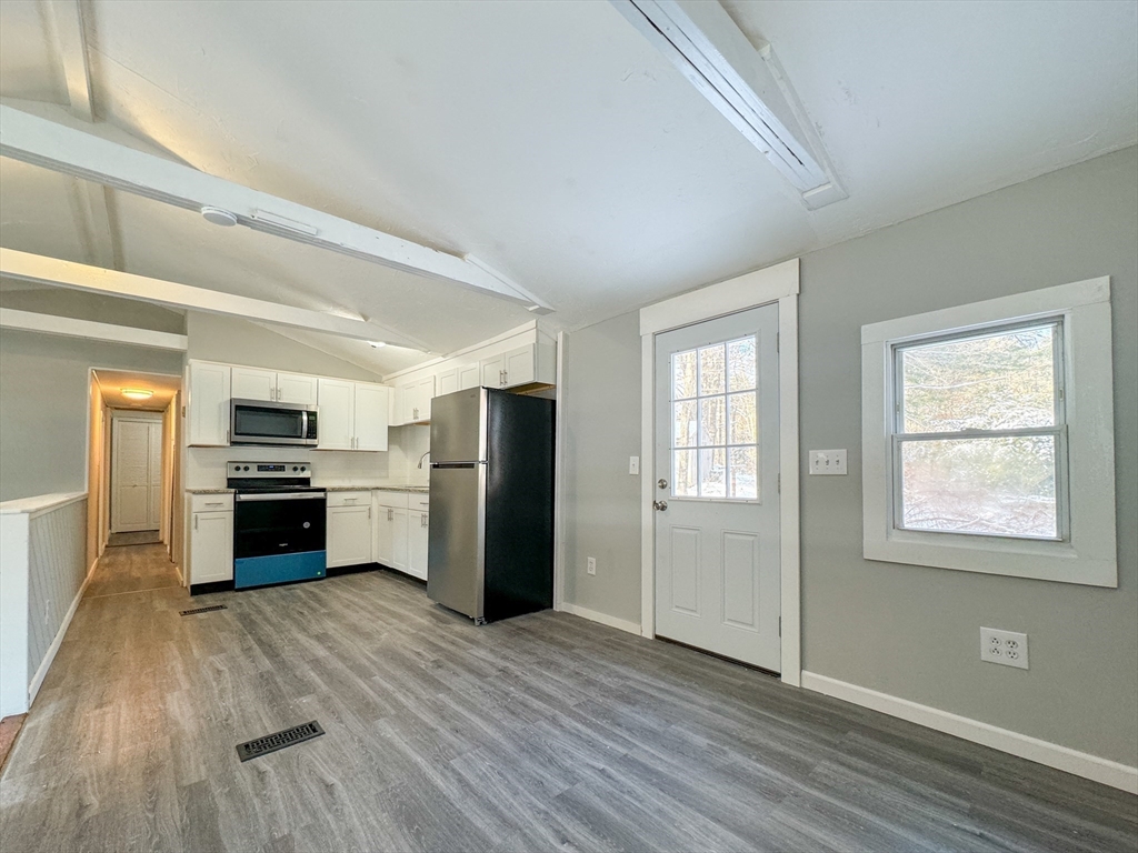 16 Schoolhouse Cross Road Brookfield, MA 01506 - Photo 9 of 39 a kitchen with a refrigerator and a stove top oven