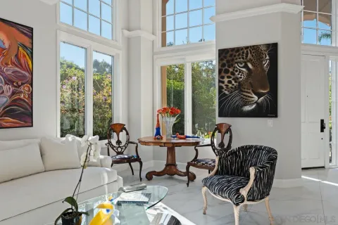 a view of a dining room with furniture a livingroom and chandelier