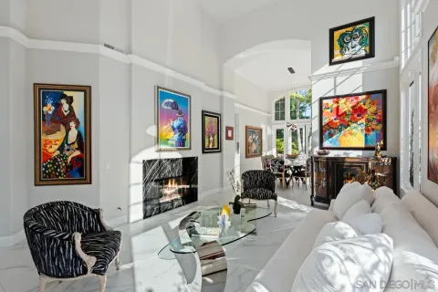 a view of a dining room with furniture a chandelier and a window