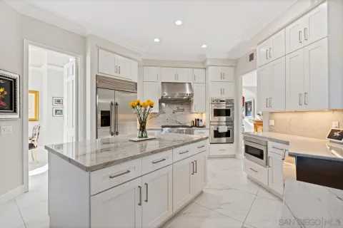a kitchen with stainless steel appliances granite countertop a sink and cabinets