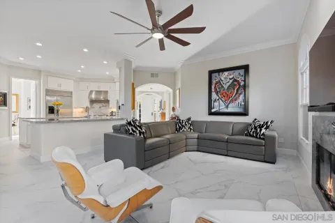 a kitchen with stainless steel appliances kitchen island granite countertop a table chairs sink and cabinets