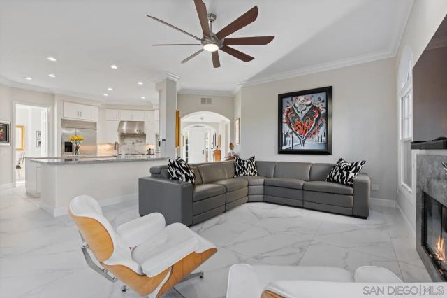 a kitchen with stainless steel appliances kitchen island granite countertop a table chairs sink and cabinets