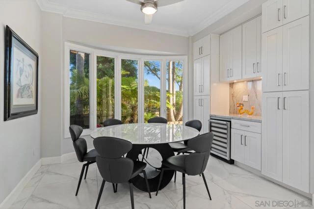 a spacious bedroom with a bed and a flat screen tv