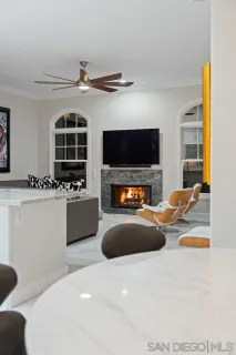 a bedroom with a bed a flat screen tv and a large window