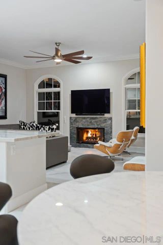 a bedroom with a bed a flat screen tv and a large window