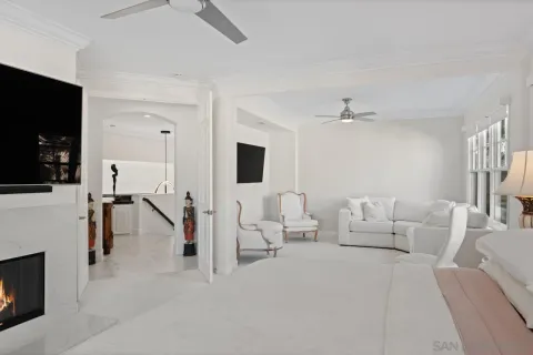 a bed room with a bed a television and a window