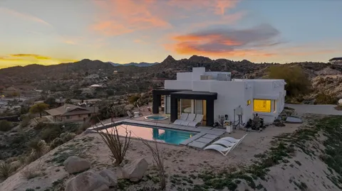 a view of a swimming pool with a yard and a fire pit