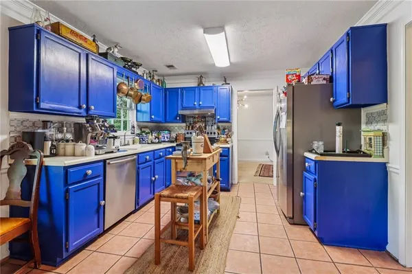 a kitchen with stainless steel appliances granite countertop a refrigerator stove top oven and sink