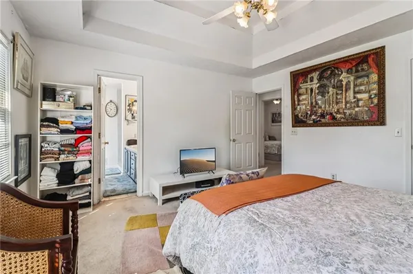 a bedroom with a bed a dresser and book self
