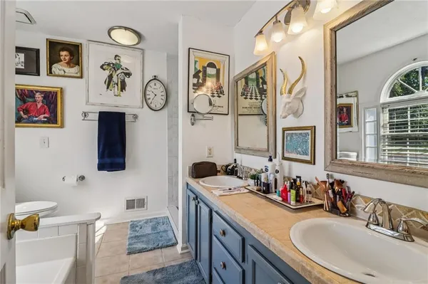 a bathroom with double vanity and a sink