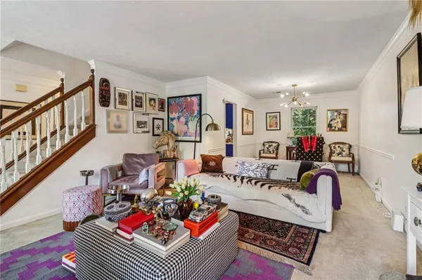 a living room with furniture a rug and a painting on the wall