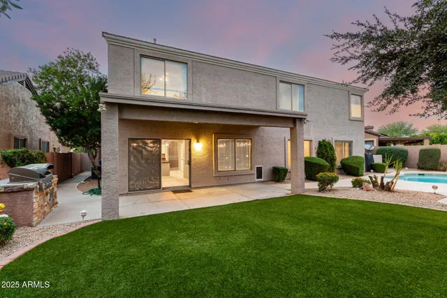 a patio with glass top table and chairs