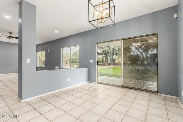 a large kitchen with stainless steel appliances a large counter top a stove and a refrigerator