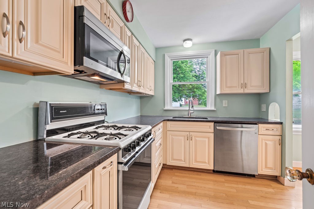 1653 Overbrook Road Cleveland, OH 44124 - Photo 16 of 29 Kitchen featuring stainless steel appliances, sink, and light wood-type flooring