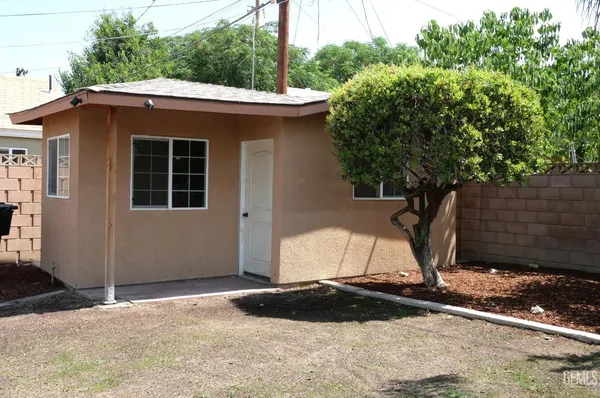 a backyard of a house with a yard and garage