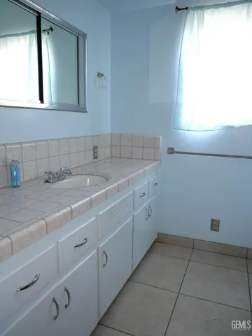 a room with a sink cabinets and utility