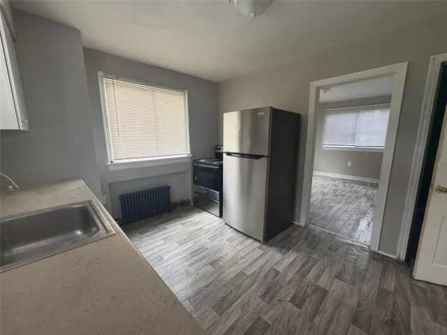 a kitchen with a refrigerator and a sink
