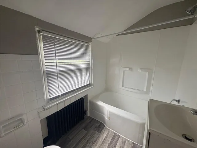 a bathroom with a bathtub and shower