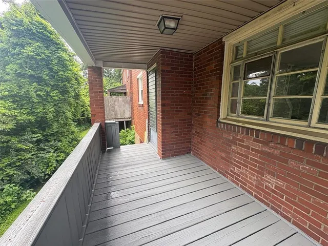 a view of a balcony with wooden floor