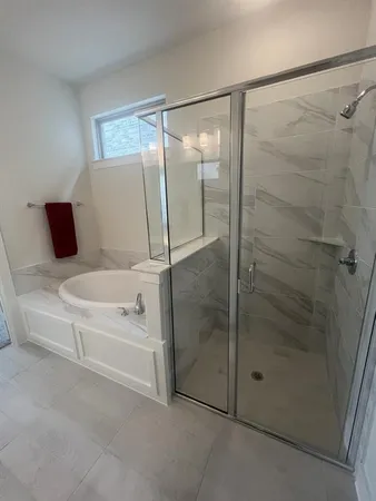 a bathroom with a bathtub and a shower