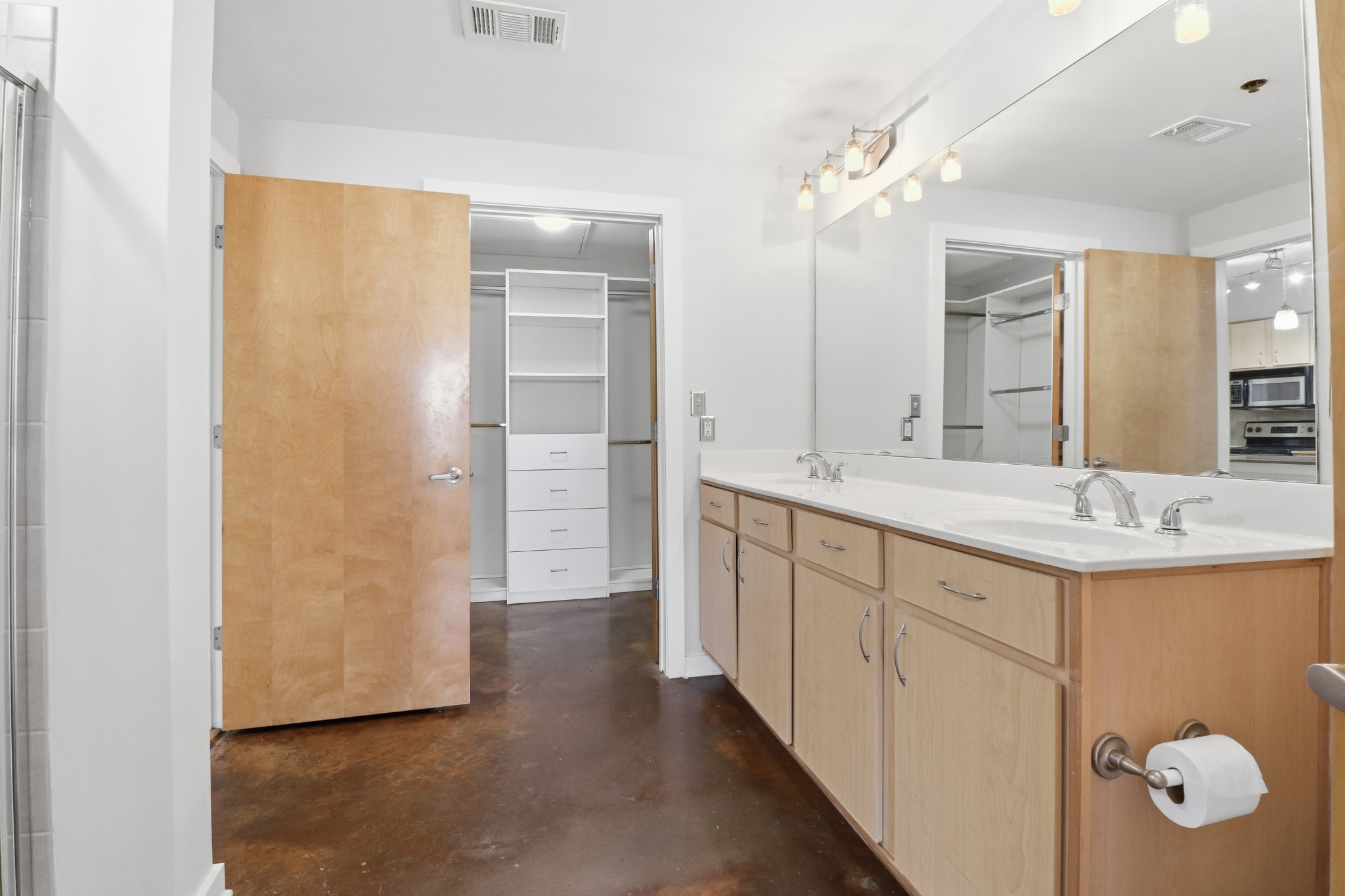 1803 Broadway, Unit 519 Nashville, TN 37203 - Photo 11 of 31 a spacious bathroom with a double vanity sink a mirror and shower