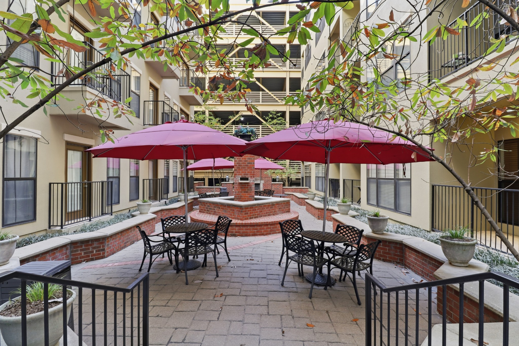 1803 Broadway, Unit 519 Nashville, TN 37203 - Photo 19 of 31 a view of a patio with a table and chairs under an umbrella
