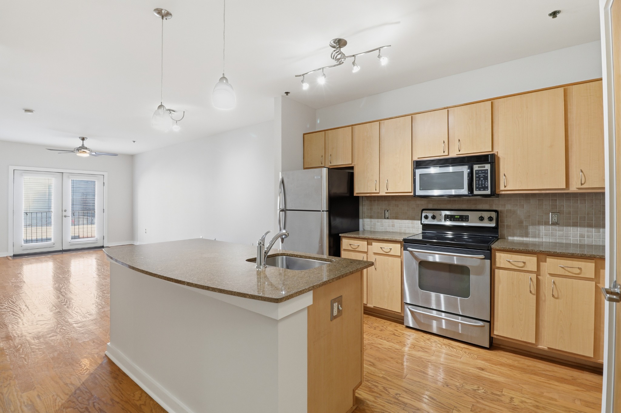 1803 Broadway, Unit 519 Nashville, TN 37203 - Photo 2 of 31 a kitchen with stainless steel appliances granite countertop a sink a stove and a refrigerator