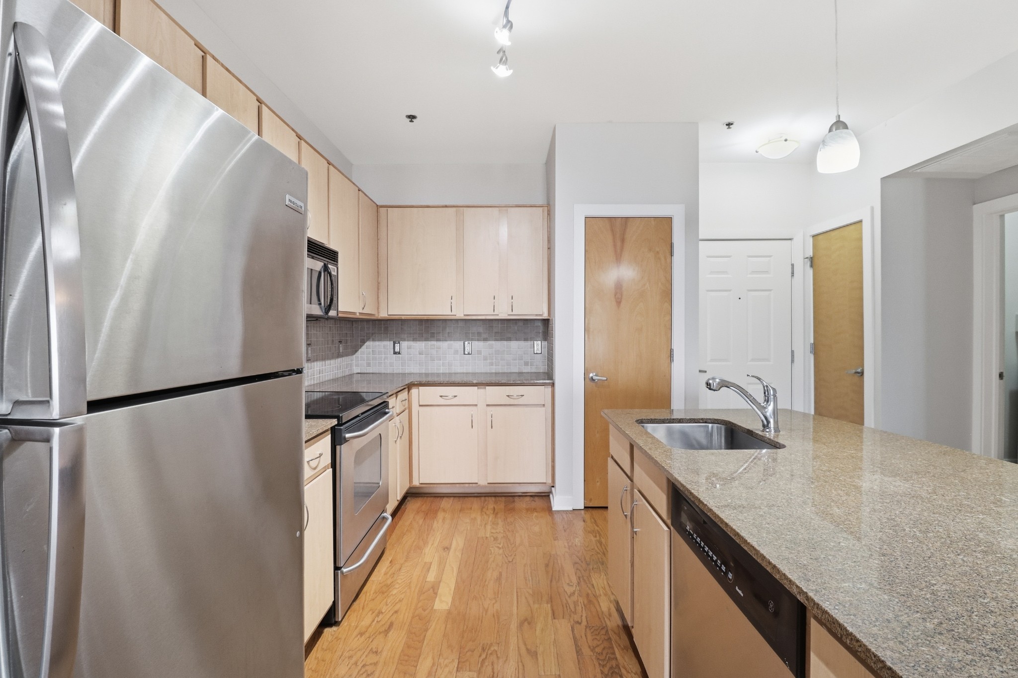 1803 Broadway, Unit 519 Nashville, TN 37203 - Photo 4 of 31 a kitchen with a refrigerator a sink and cabinets