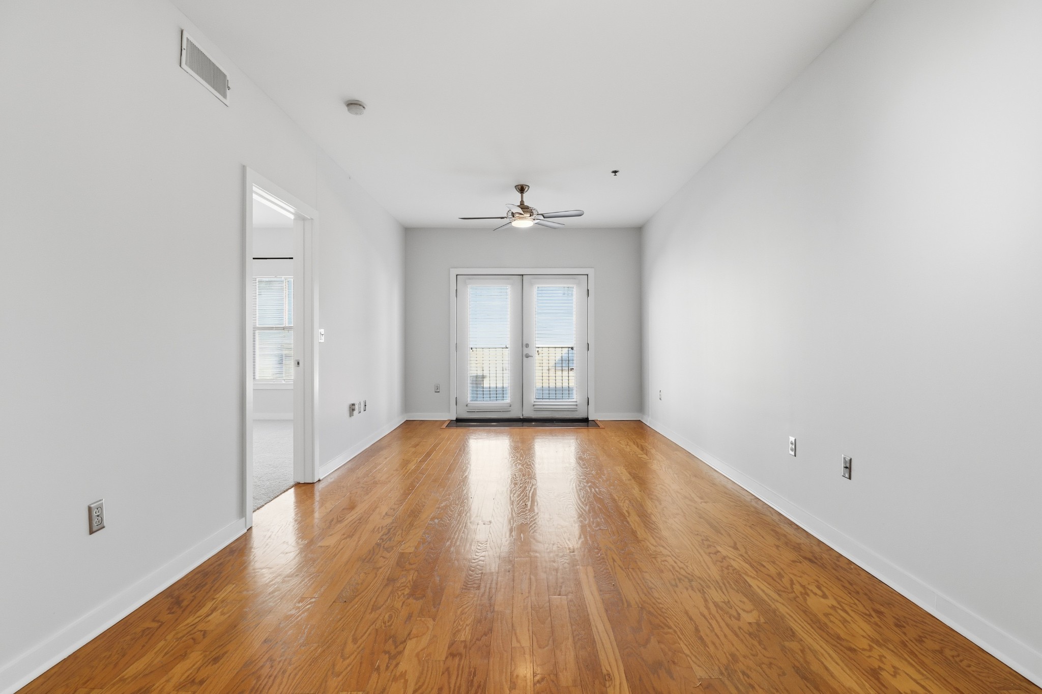 1803 Broadway, Unit 519 Nashville, TN 37203 - Photo 7 of 31 an empty room with wooden floor and windows