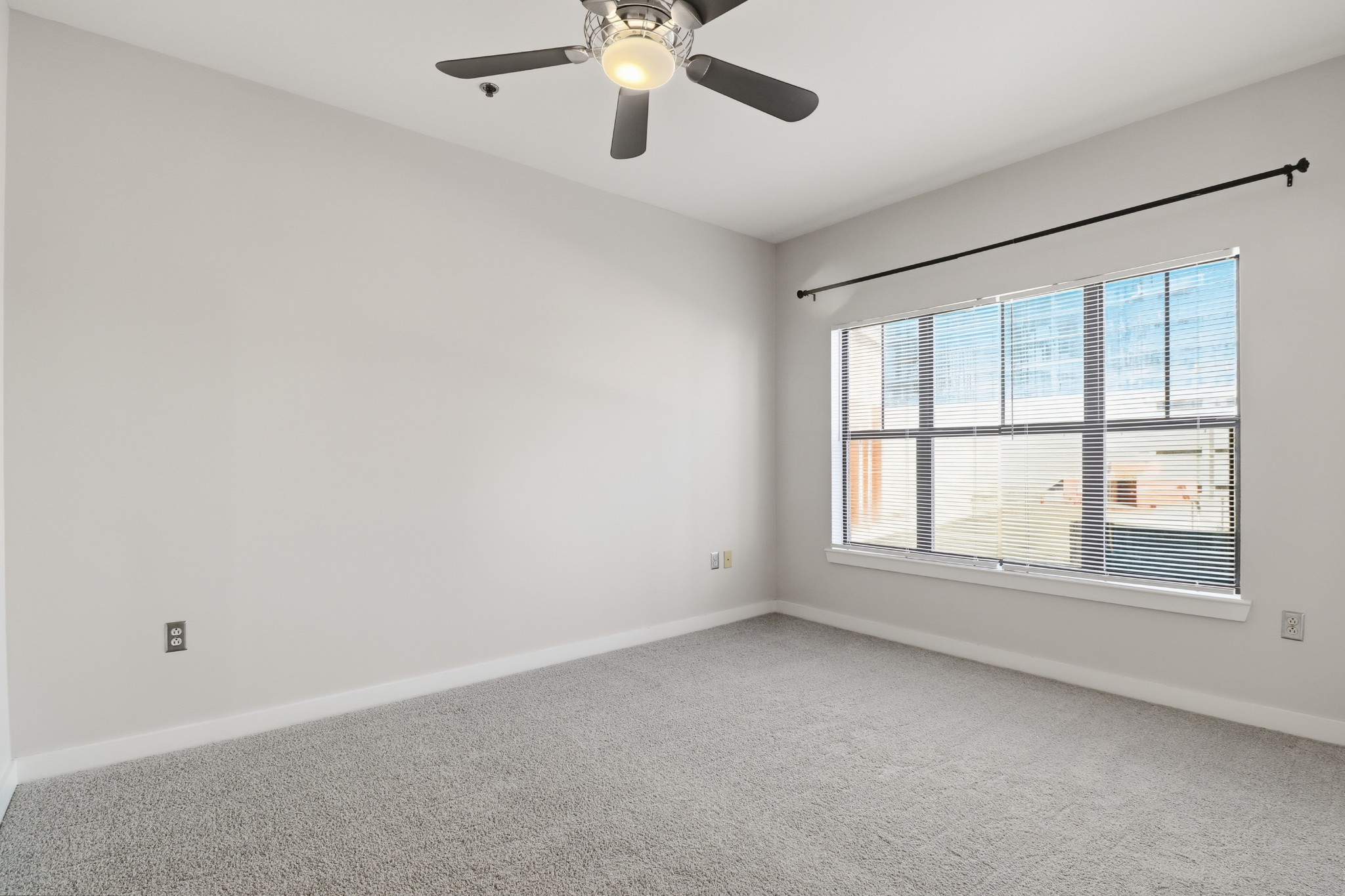 1803 Broadway, Unit 519 Nashville, TN 37203 - Photo 9 of 31 an empty room with chandelier fan and windows