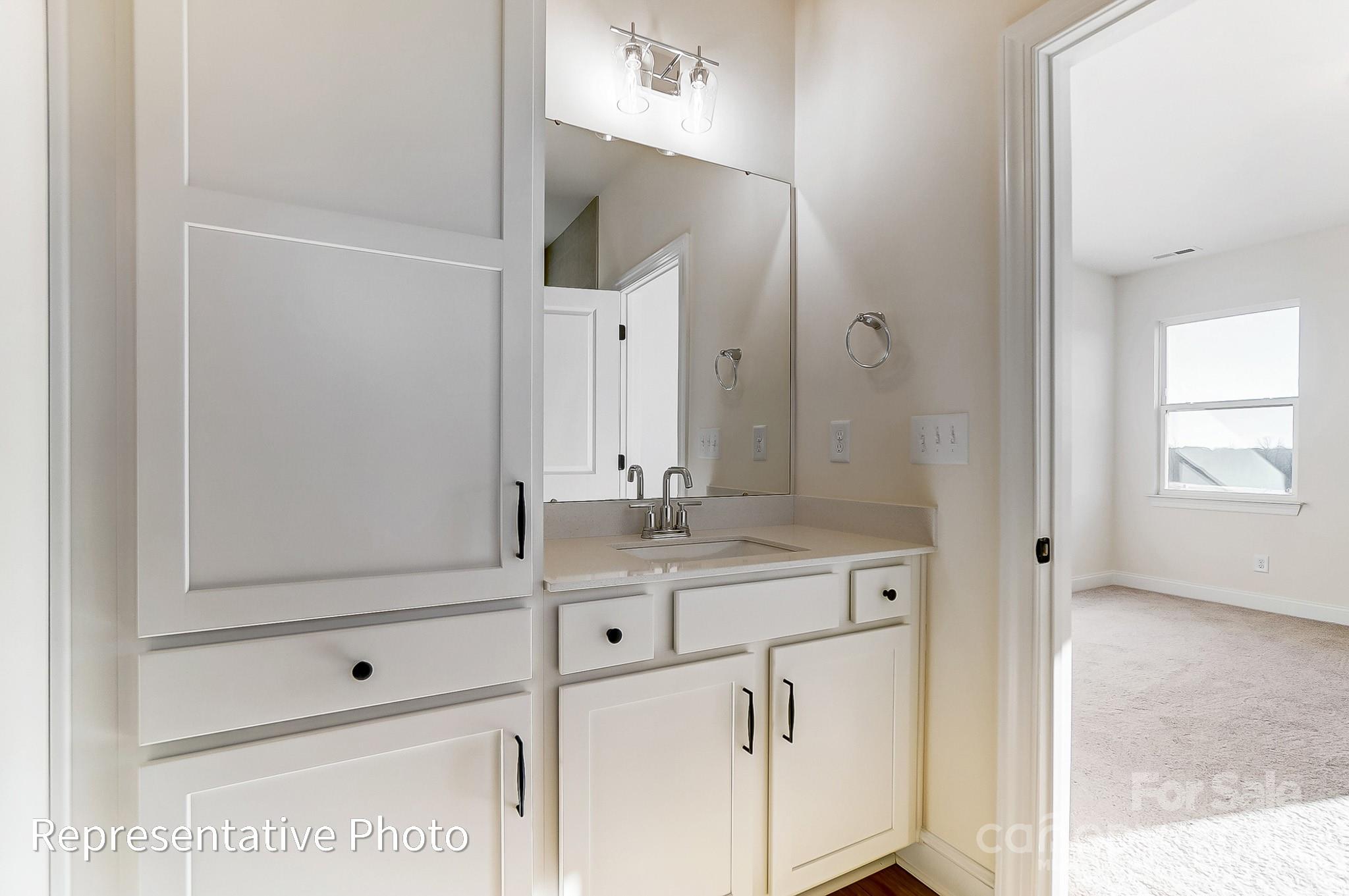 5009 Raging Crk Drive Indian Trail, NC 28079 - Photo 13 of 28 a bathroom with a sink vanity granite and a mirror