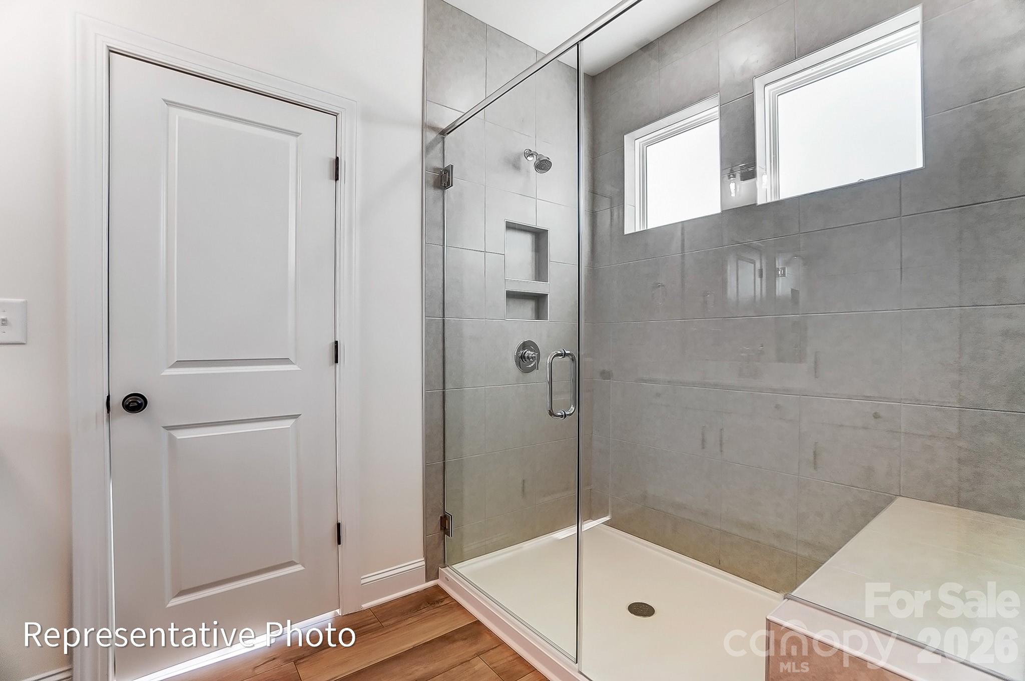 5009 Raging Crk Drive Indian Trail, NC 28079 - Photo 14 of 39 a bathroom with a glass shower door