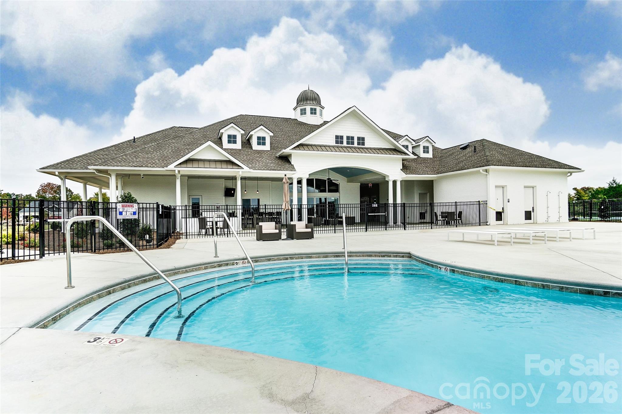 5009 Raging Crk Drive Indian Trail, NC 28079 - Photo 35 of 39 a view of white house with swimming pool and chairs