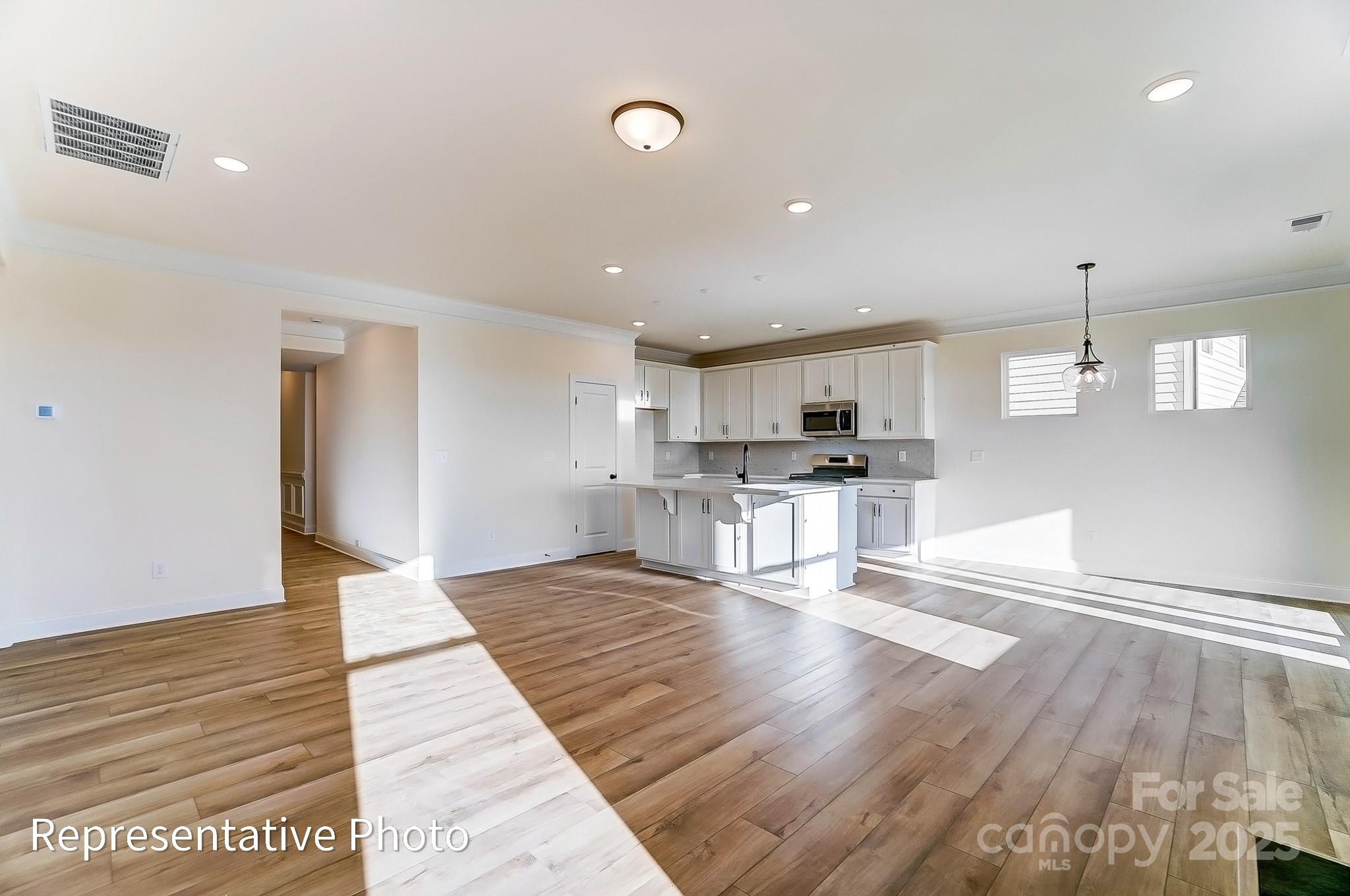 5009 Raging Crk Drive Indian Trail, NC 28079 - Photo 6 of 28 a view of kitchen with cabinets and wooden floor