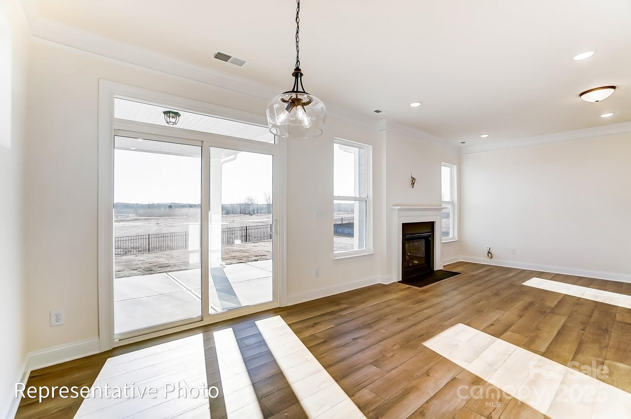 5009 Raging Crk Drive Indian Trail, NC 28079 - Photo 10 of 28 a view of an empty room with a fireplace and a window