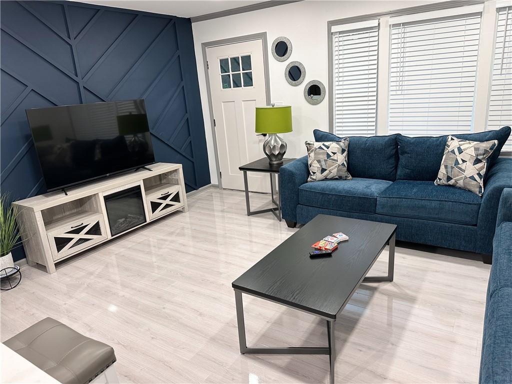 a living room with furniture and a flat screen tv