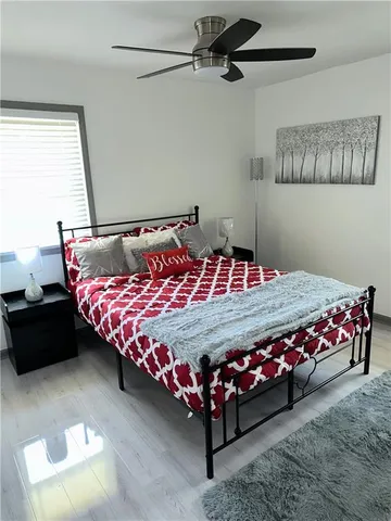 a bed sitting in a bedroom next to a window