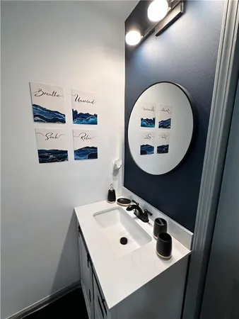 a bathroom with a sink mirror and vanity